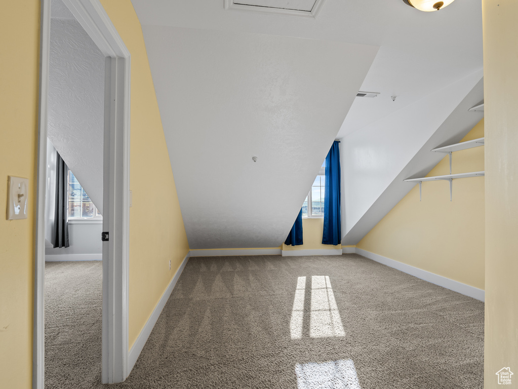 Bonus room featuring baseboards, carpet flooring, and lofted ceiling