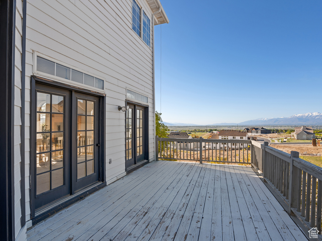 Wooden terrace featuring french doors and a mountain view