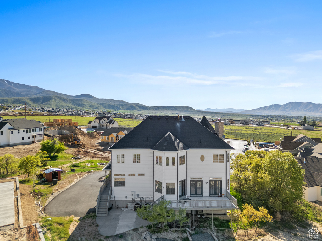 Rear view of house with a mountain view and a chimney