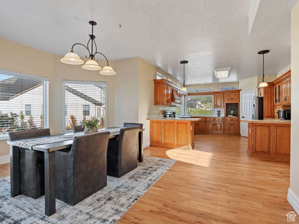 Dining space with baseboards and light wood-style flooring