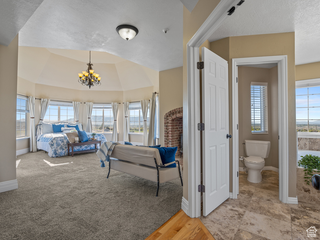 Bedroom featuring baseboards, an inviting chandelier, and a textured ceiling