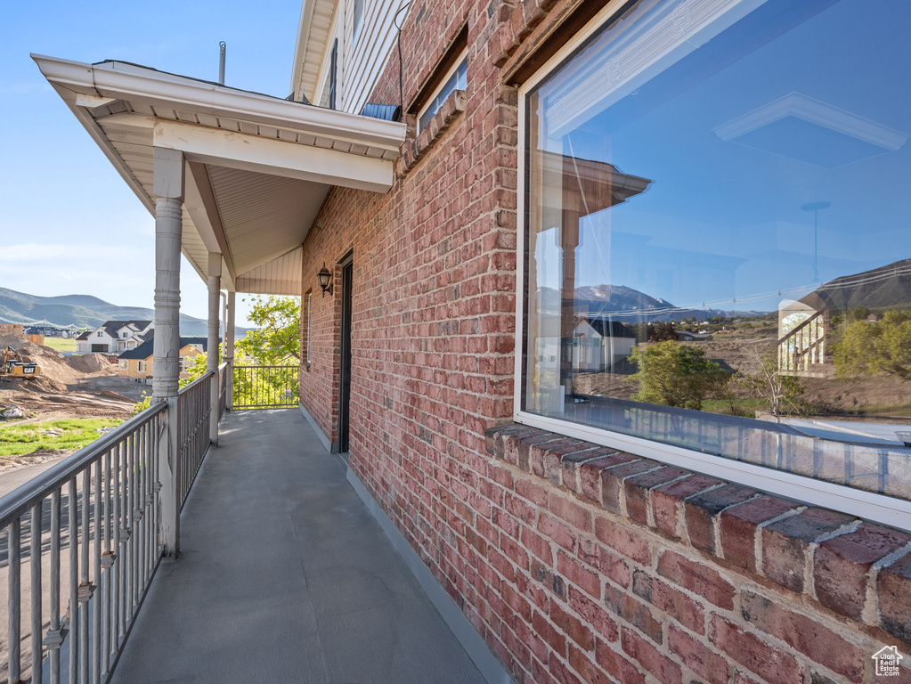 View of side of property with a mountain view and brick siding