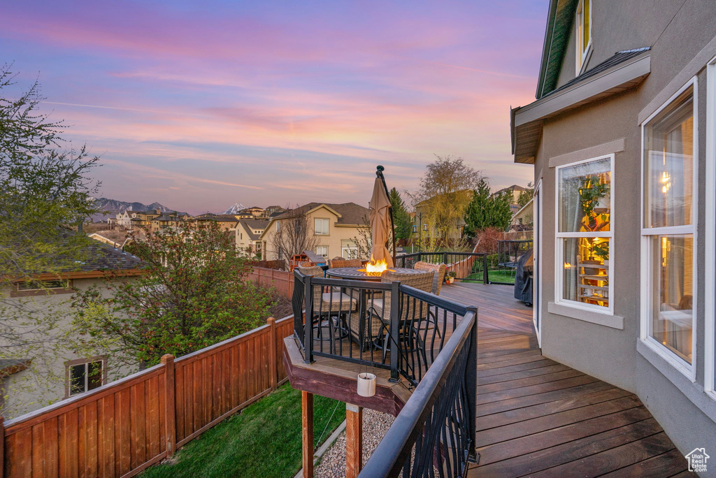 Deck with a residential view, a fire pit, and a fenced backyard