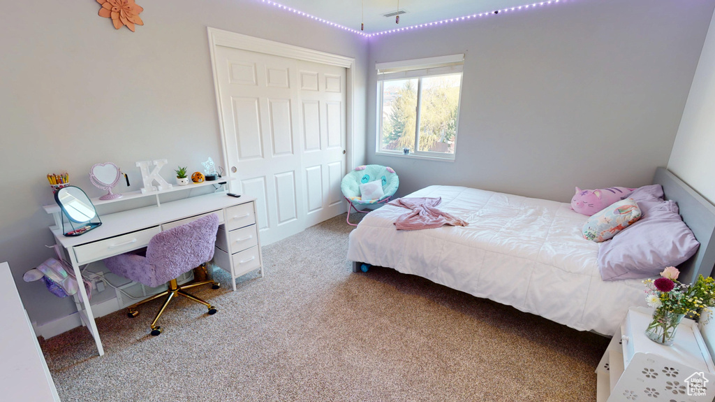 Carpeted bedroom with a closet