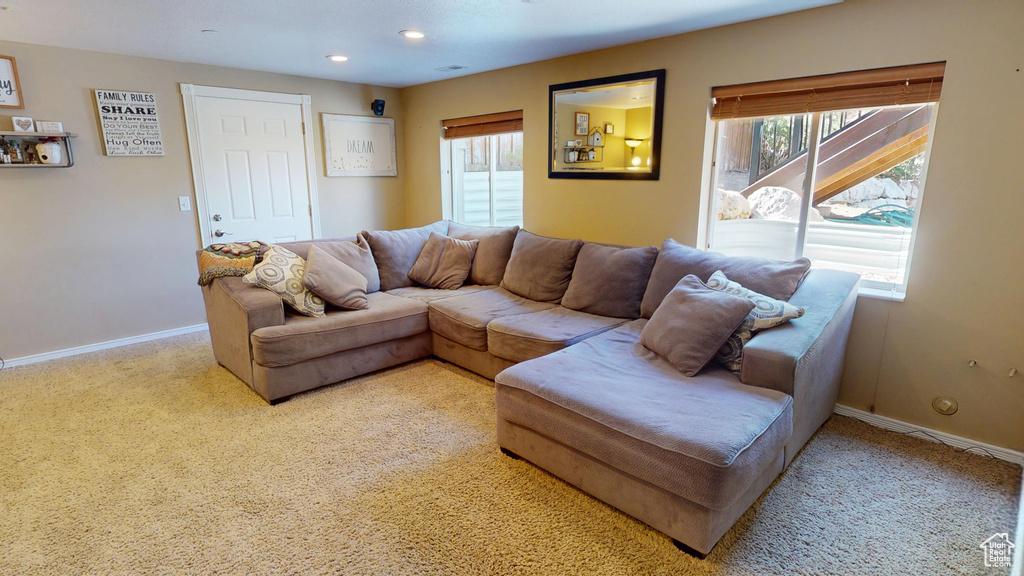 Carpeted living area featuring baseboards and recessed lighting