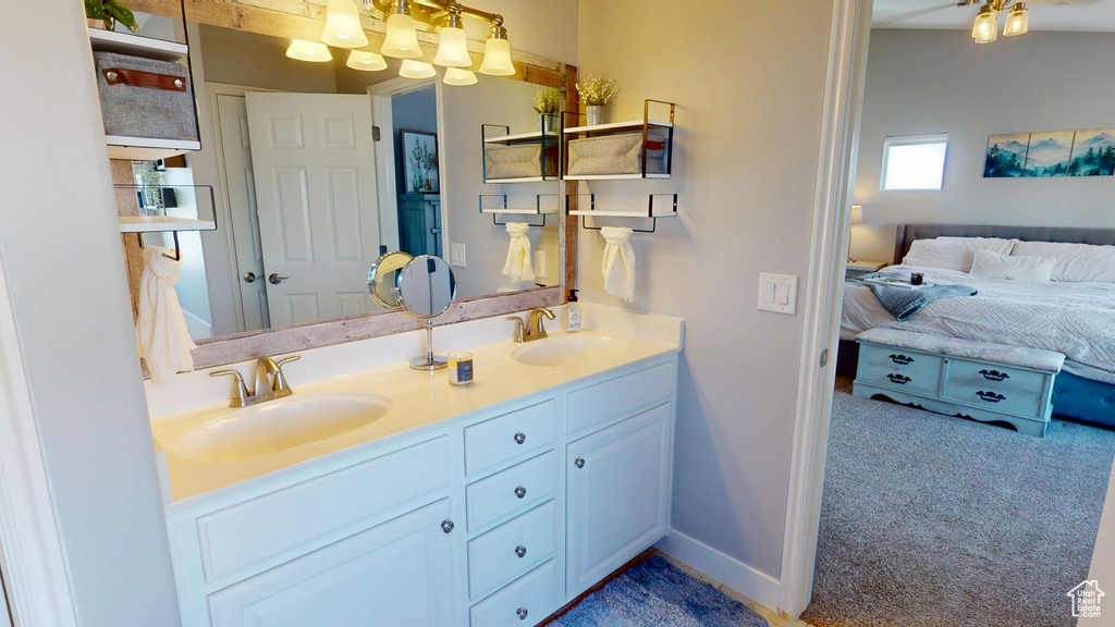 Full bath featuring a sink, ensuite bath, and double vanity