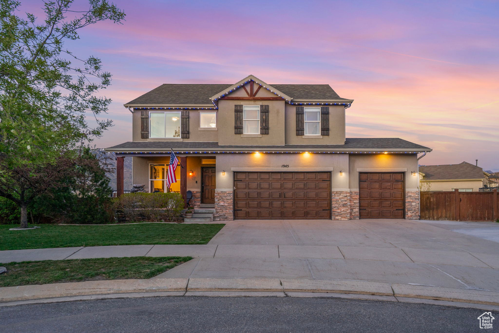 Craftsman house featuring stone siding, stucco siding, and fence