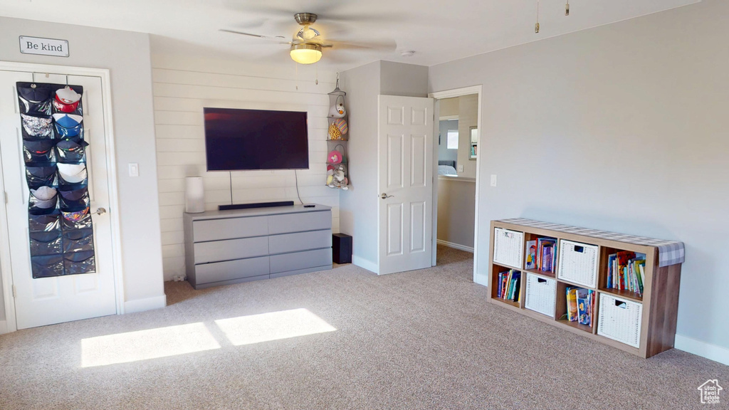 Interior space featuring carpet floors, baseboards, and a ceiling fan