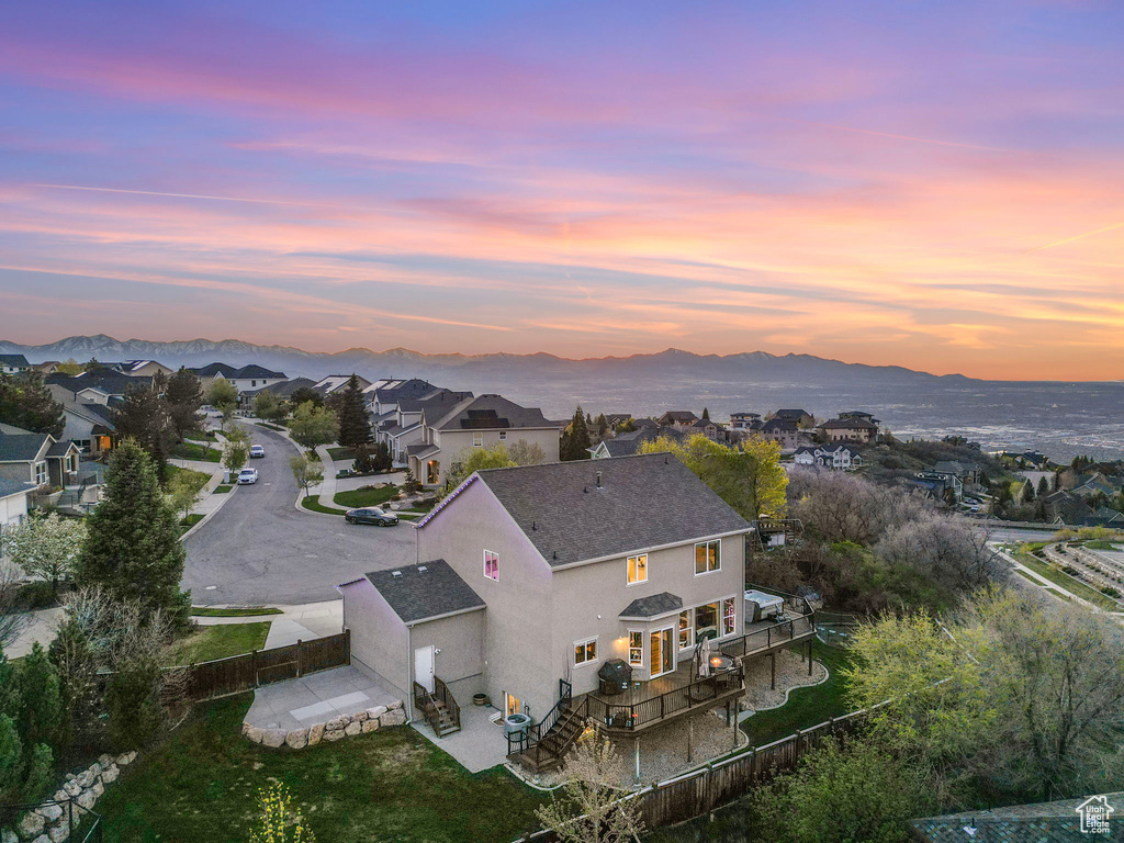 Aerial view at dusk featuring a mountain view and a residential view