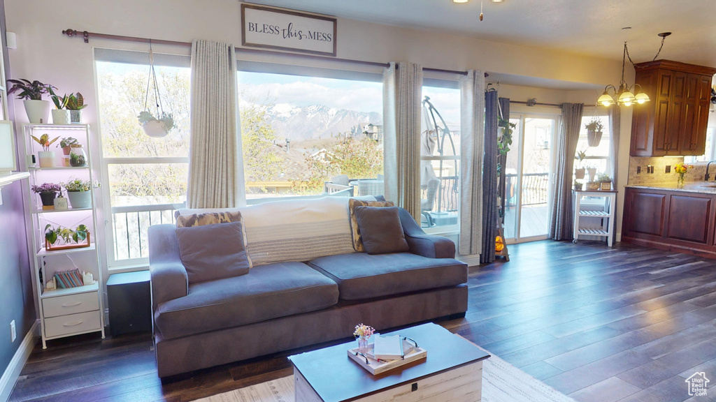 Living area featuring plenty of natural light and dark wood-type flooring