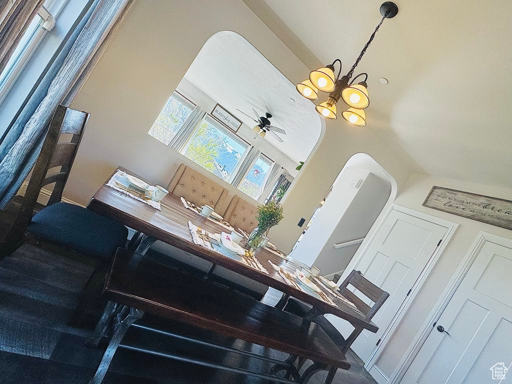 Interior space featuring ceiling fan with notable chandelier