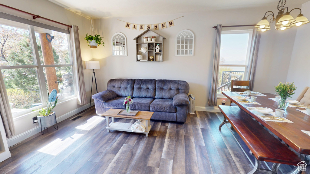 Living room with visible vents, plenty of natural light, and wood finished floors