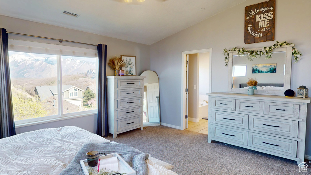 Bedroom with multiple windows, vaulted ceiling, visible vents, and light colored carpet