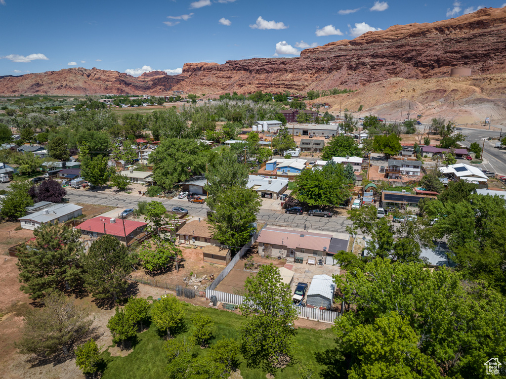 Aerial view of property and surrounding area with a mountainous background
