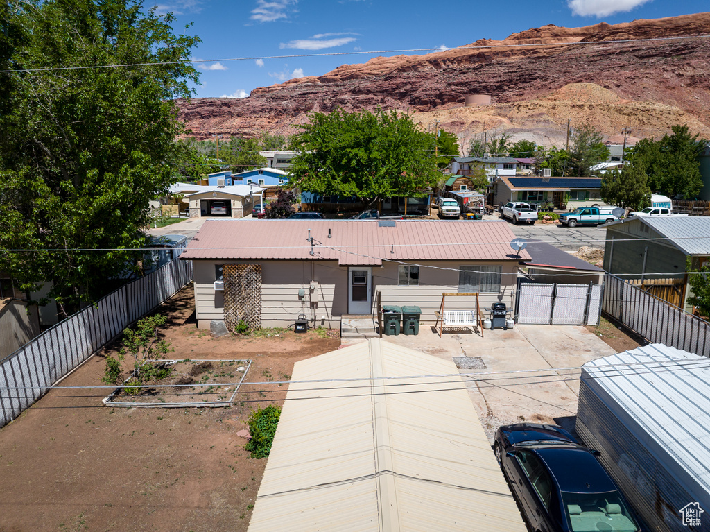 View of front of home with a mountain view and a fenced backyard