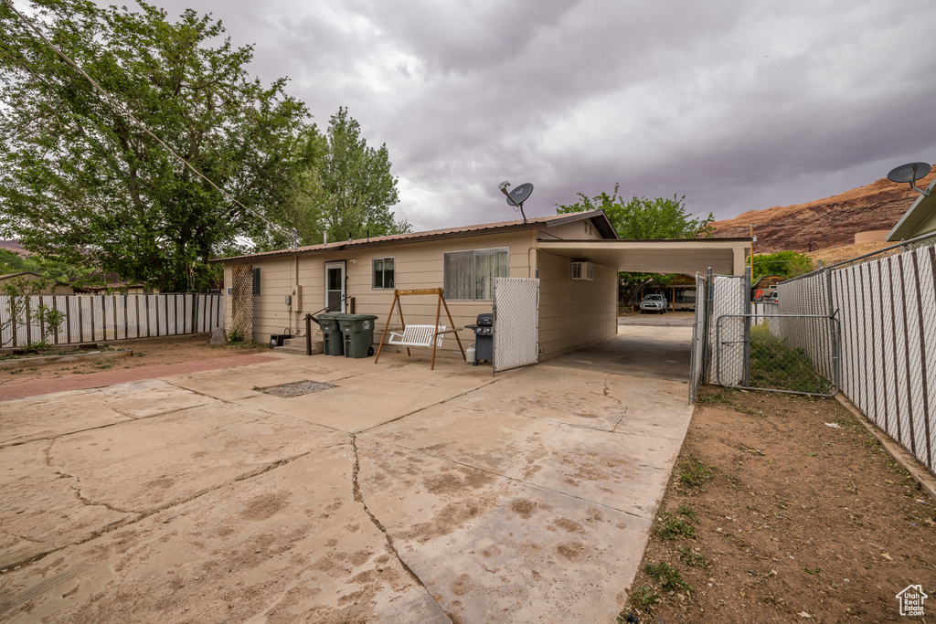 Back of property with fence and concrete driveway