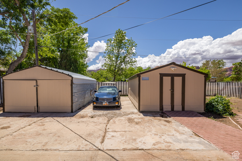 View of shed featuring fence