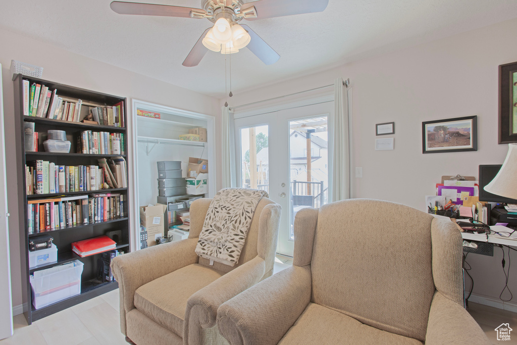 Sitting room featuring a ceiling fan