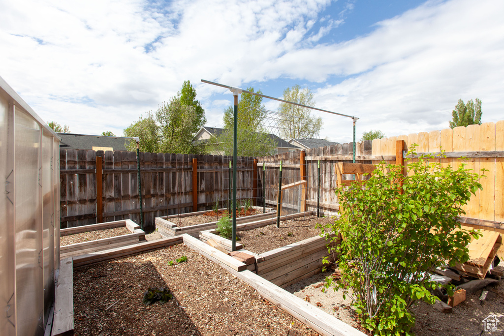 View of yard featuring a garden and a fenced backyard