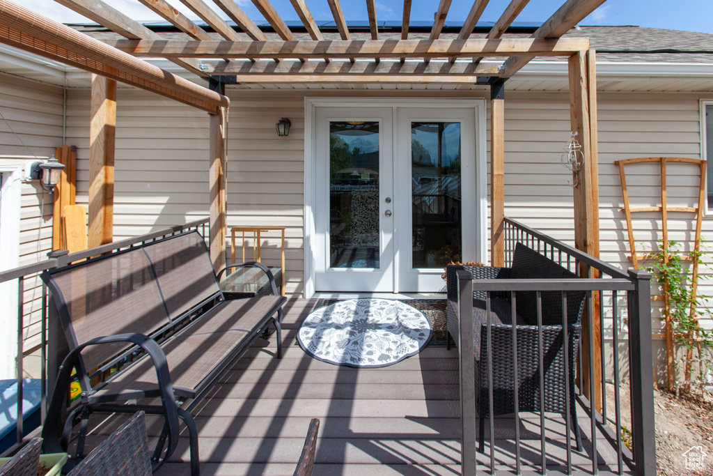 Wooden terrace with french doors and a pergola