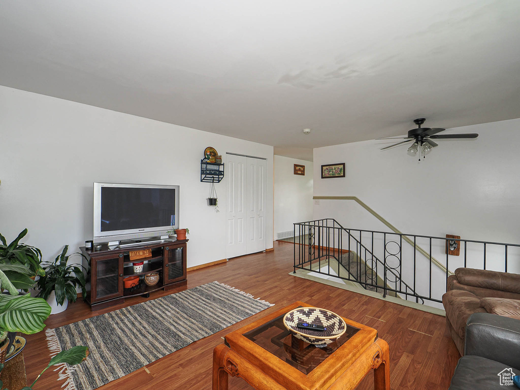 Living area with ceiling fan and wood finished floors