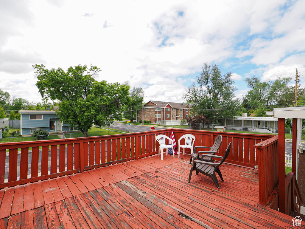 Wooden deck with a residential view and fence