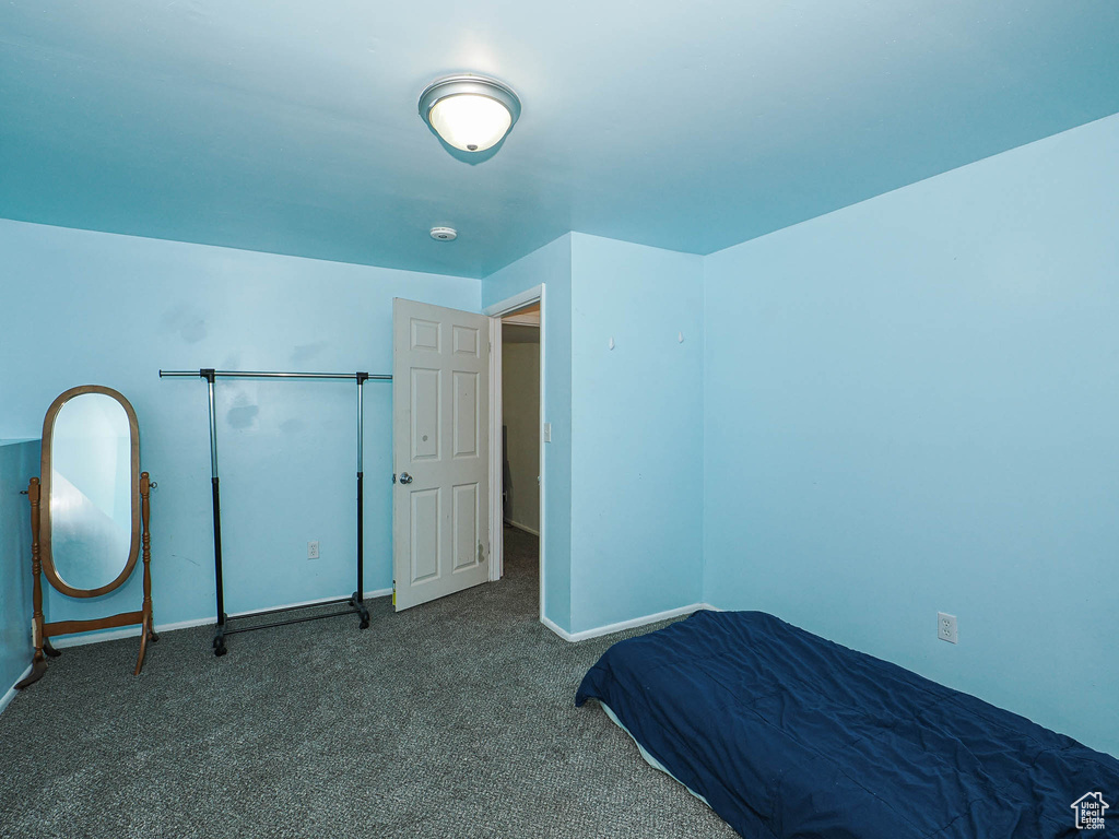 Unfurnished bedroom with carpet and baseboards