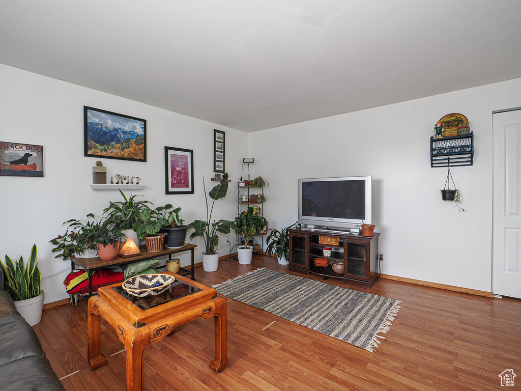 Living area with wood finished floors and baseboards