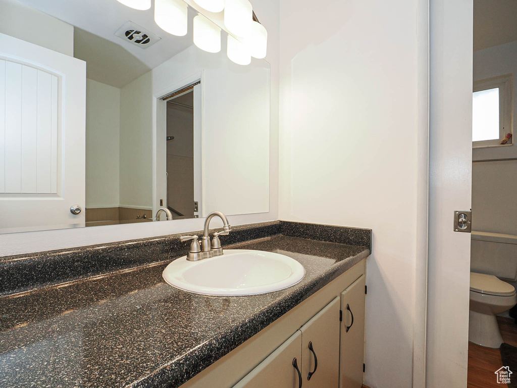 Bathroom featuring vanity and toilet
