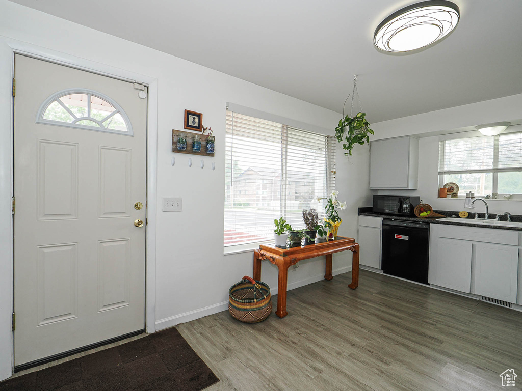 Foyer entrance with light wood-type flooring and baseboards