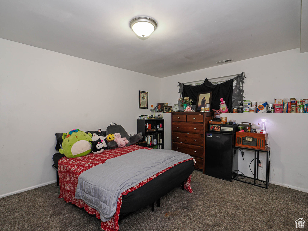 Carpeted bedroom featuring baseboards