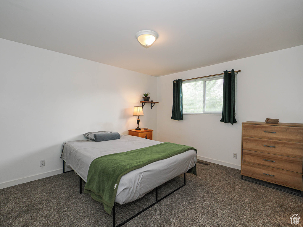 Carpeted bedroom with baseboards