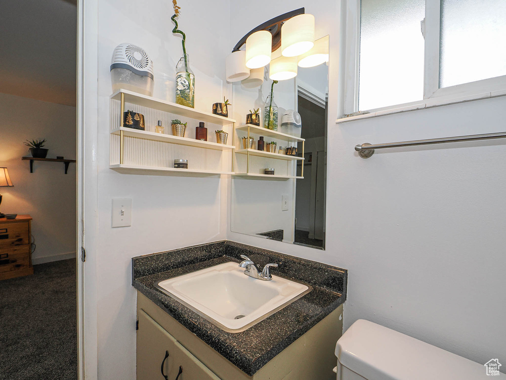 Half bathroom featuring toilet and vanity