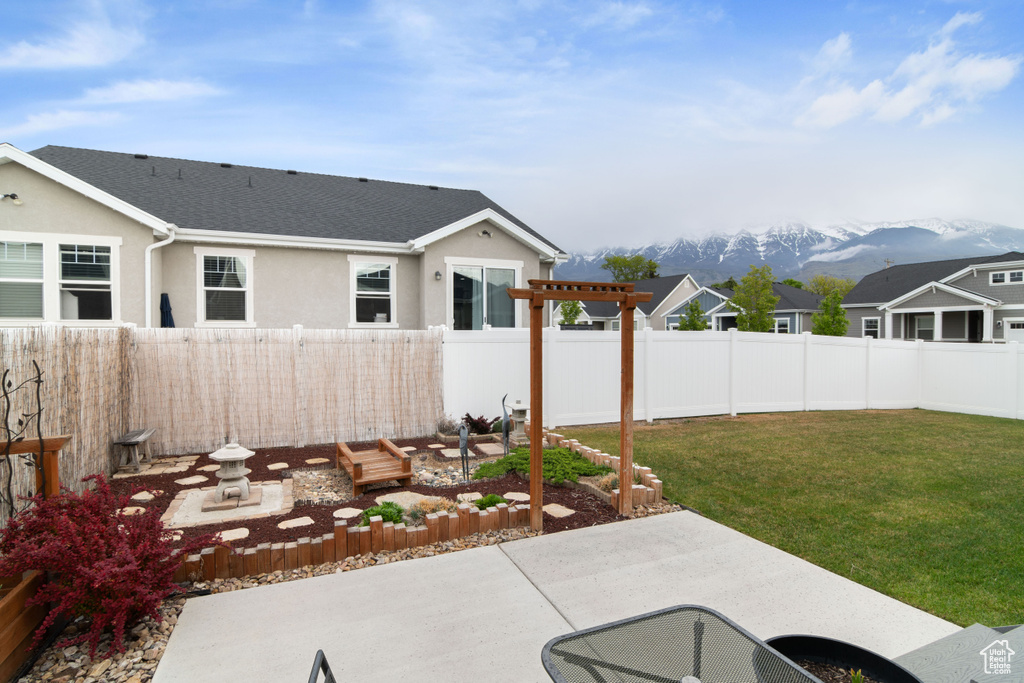 View of yard with a patio area, a pergola, and a mountain view