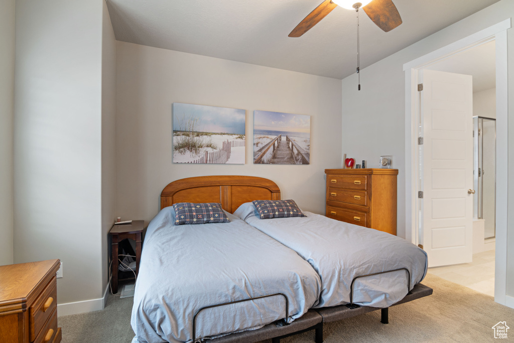Bedroom with light carpet, a ceiling fan, and baseboards