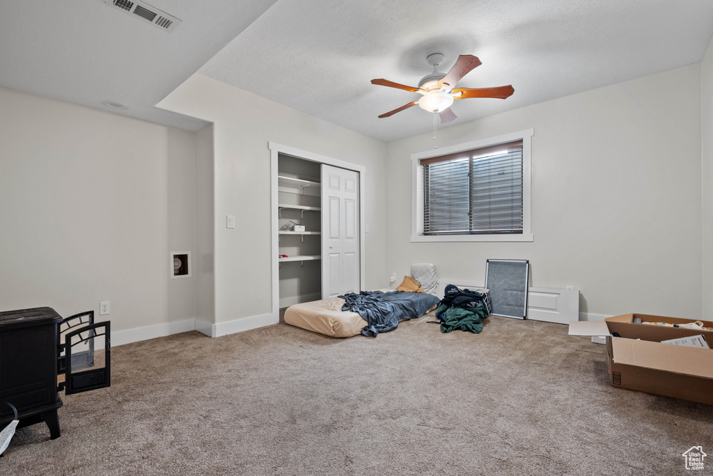Interior space with ceiling fan, a closet, baseboards, and visible vents