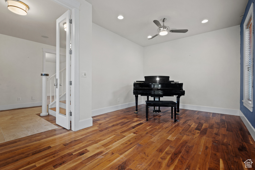 Living area featuring a ceiling fan, baseboards, recessed lighting, and hardwood / wood-style flooring
