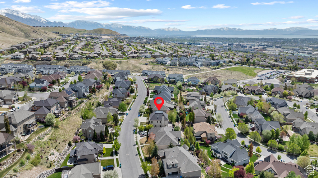 Birds eye view of property with a mountain view and a residential view