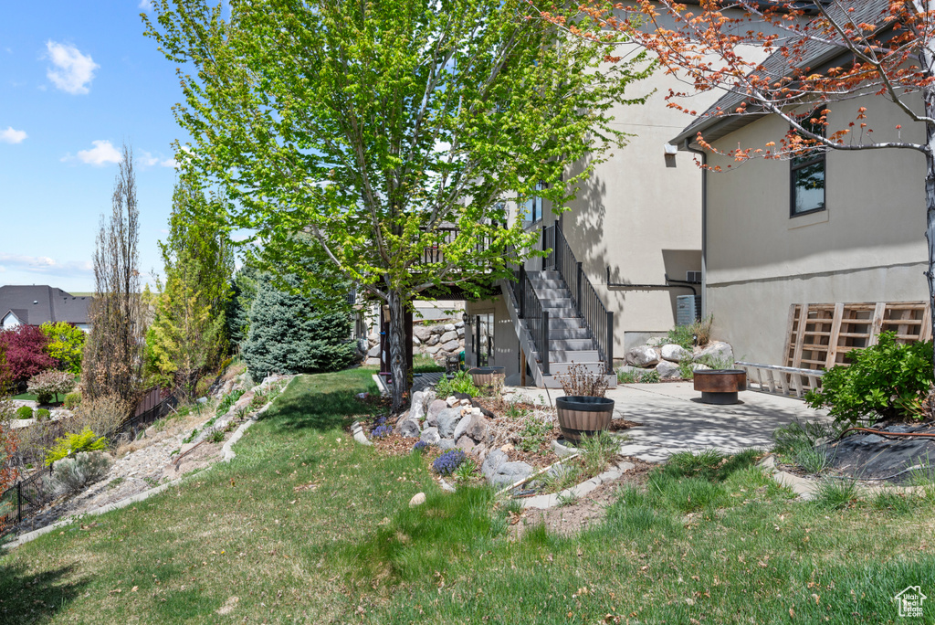 View of yard featuring stairway and a patio