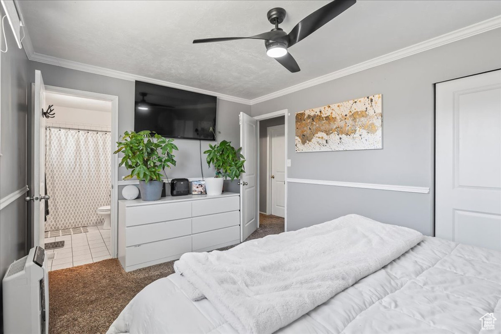 Bedroom featuring crown molding, carpet, ensuite bathroom, and ceiling fan