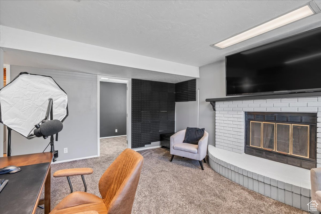 Interior space with a fireplace, carpet floors, and baseboards