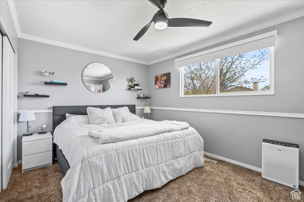 Bedroom with ornamental molding and carpet floors