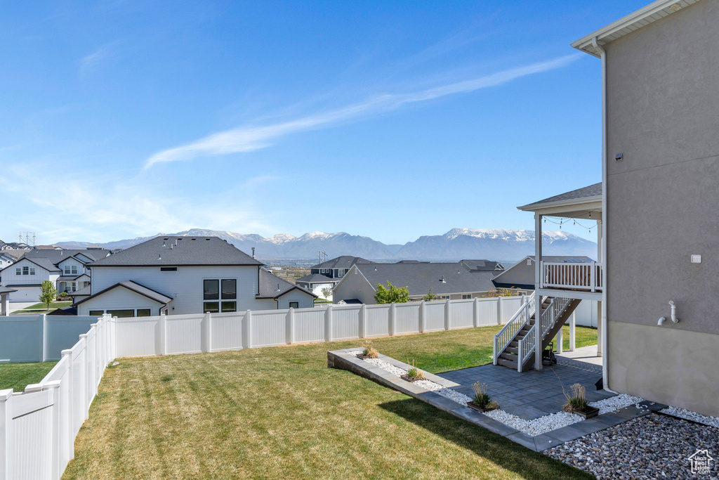 View of yard with a patio, a residential view, a mountain view, and a fenced backyard