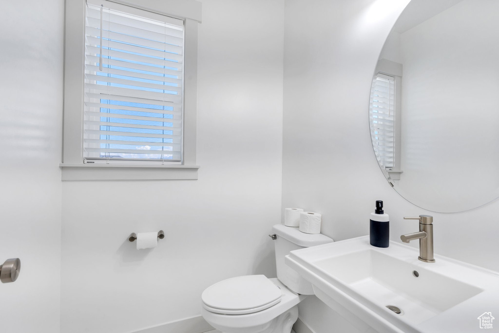 Half bath featuring a sink and toilet