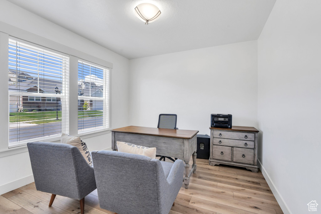Home office featuring baseboards and light wood-type flooring