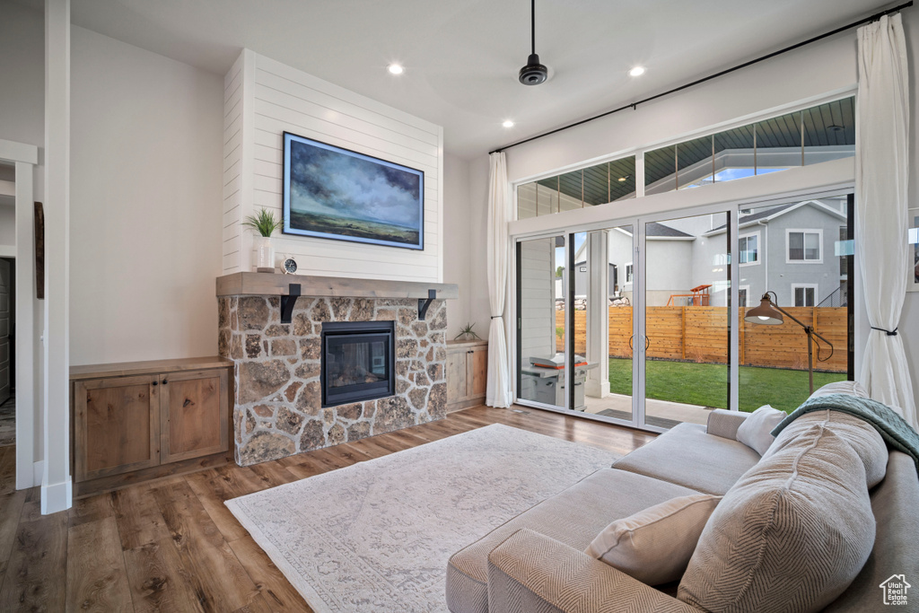 Living room with a fireplace, recessed lighting, and wood finished floors