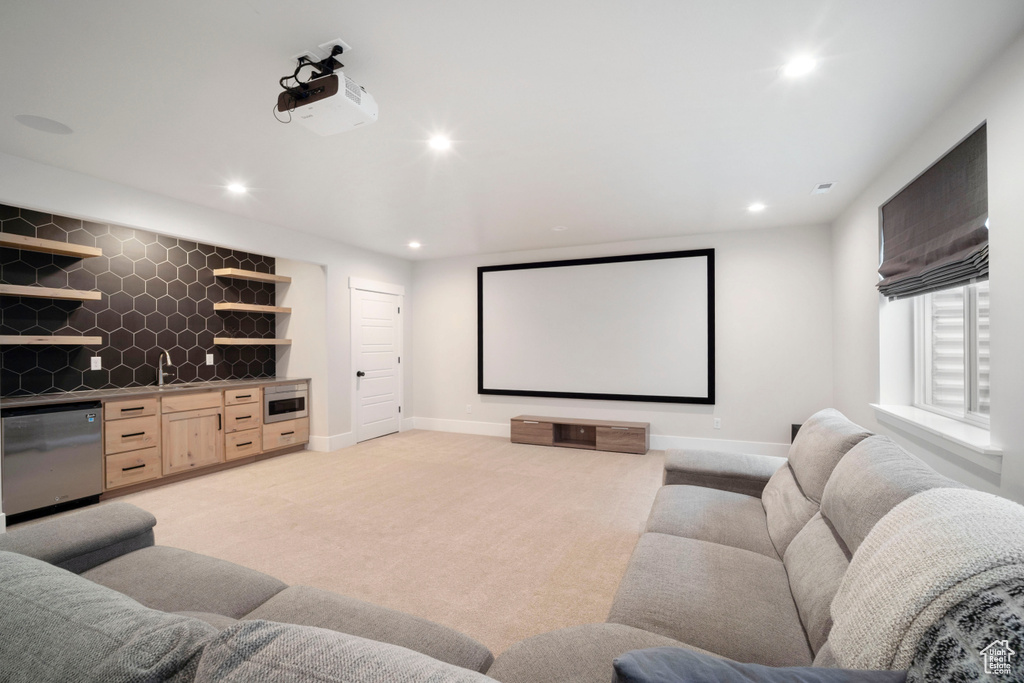Cinema featuring baseboards, recessed lighting, light colored carpet, and indoor wet bar