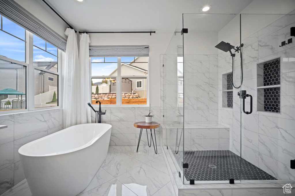Full bathroom with a soaking tub, marble finish floor, a stall shower, and recessed lighting