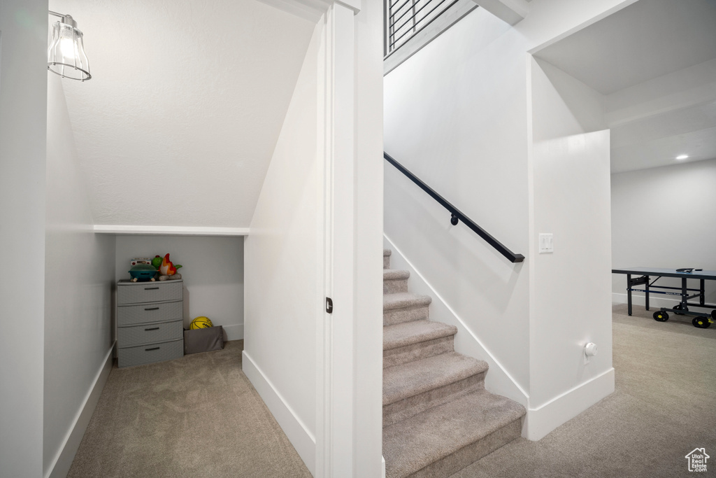 Stairway featuring carpet flooring and baseboards
