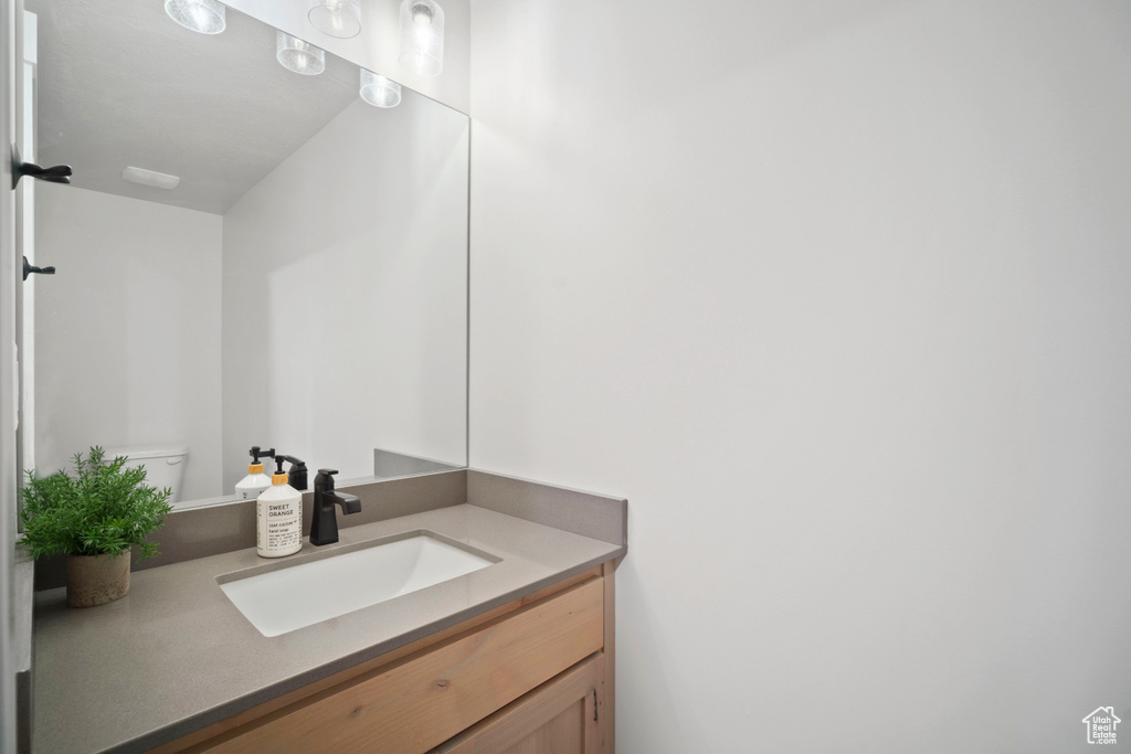 Half bath featuring toilet and vanity